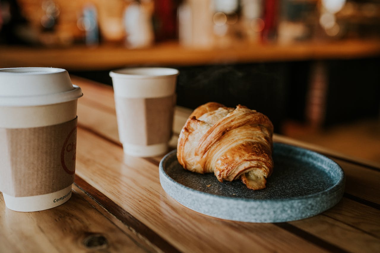 A croissant and two coffees